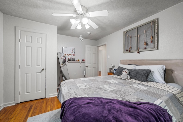 1205 Ashleman St, Bellmead, TX 76705 - bedroom with wood finished floors, a textured ceiling, and ceiling fan