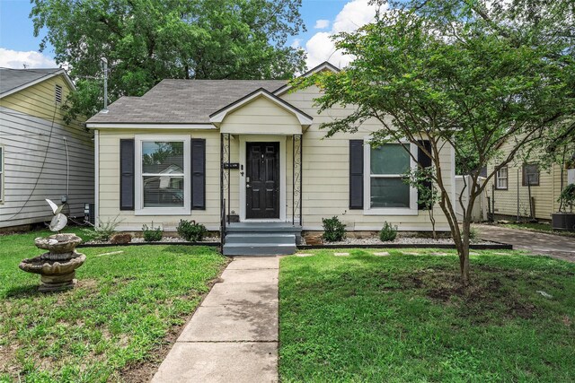 1205 Ashleman St, Bellmead, TX 76705 - view of front of house featuring a front yard and roof with shingles