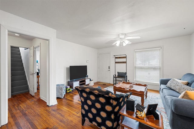 1205 Ashleman St, Bellmead, TX 76705 - living area featuring stairs, wood finished floors, and a ceiling fan