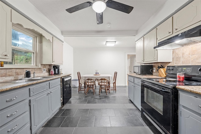 1205 Ashleman St, Bellmead, TX 76705 - kitchen with black appliances, gray cabinets, under cabinet range hood, and backsplash