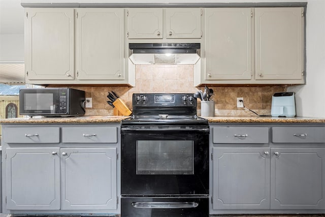 1205 Ashleman St, Bellmead, TX 76705 - kitchen featuring black appliances, under cabinet range hood, tasteful backsplash, light countertops, and white cabinets