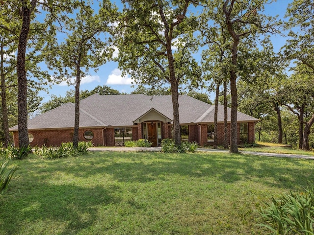 1210 Oak View Ct, Oak Point, TX 75068 - view of front facade with brick siding, a front yard, and roof with shingles