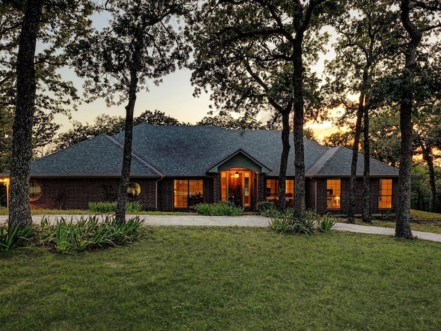 1210 Oak View Ct, Oak Point, TX 75068 - view of front of house with a front yard, a shingled roof, and brick siding