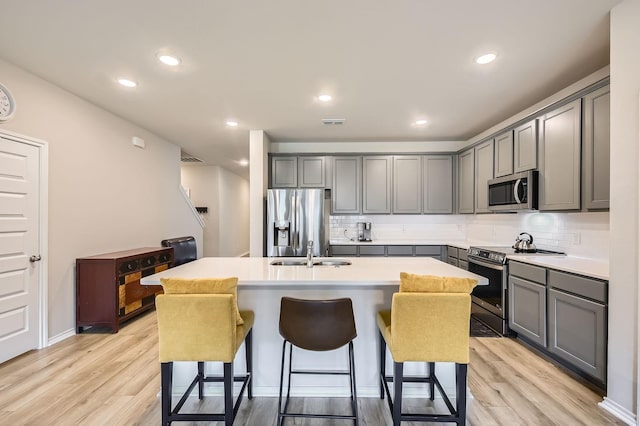 8009 Gangway Dr, Fort Worth, TX 76179 - kitchen with stainless steel appliances, gray cabinets, light wood-style floors, and recessed lighting