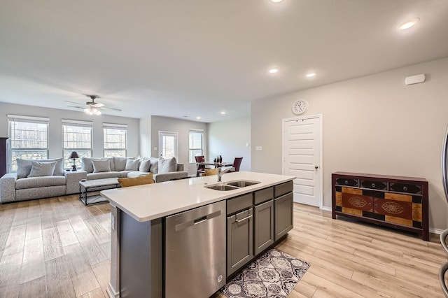 8009 Gangway Dr, Fort Worth, TX 76179 - kitchen with stainless steel dishwasher, light countertops, light wood finished floors, an island with sink, and ceiling fan