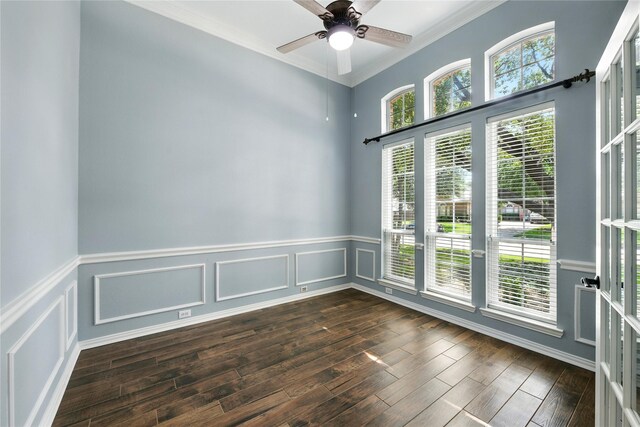 2908 Carterton Ct, Flower Mound, TX 75022 - empty room featuring crown molding, dark wood-style floors, a wainscoted wall, ceiling fan, and a decorative wall
