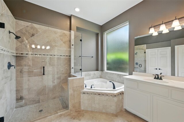 2908 Carterton Ct, Flower Mound, TX 75022 - bathroom with a garden tub, vanity, a stall shower, and plenty of natural light