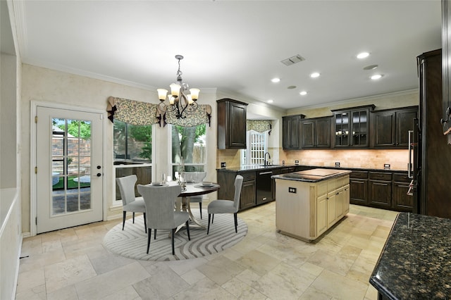 2908 Carterton Ct, Flower Mound, TX 75022 - kitchen with dishwasher, healthy amount of natural light, a chandelier, ornamental molding, and dark brown cabinets