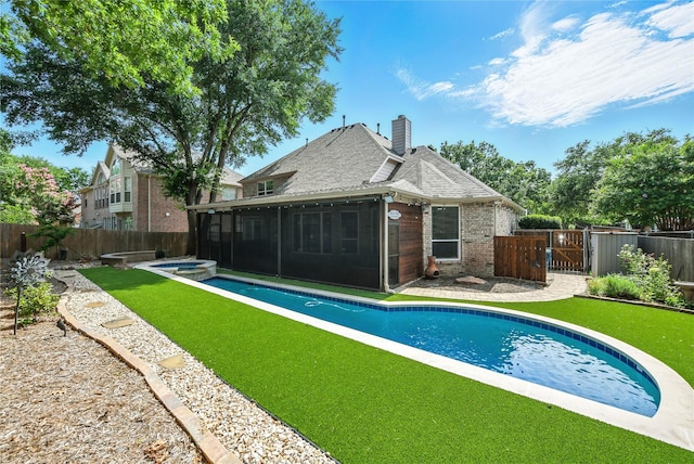 2908 Carterton Ct, Flower Mound, TX 75022 - back of house with a sunroom, a gate, brick siding, and a fenced backyard