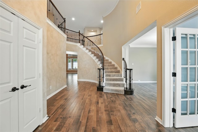 2908 Carterton Ct, Flower Mound, TX 75022 - foyer featuring wood-type flooring, stairway, ornamental molding, and a high ceiling