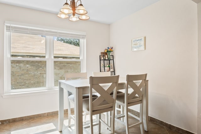 7220 Elderberry Ln, Dallas, TX 75249 - tiled dining room featuring a chandelier and baseboards