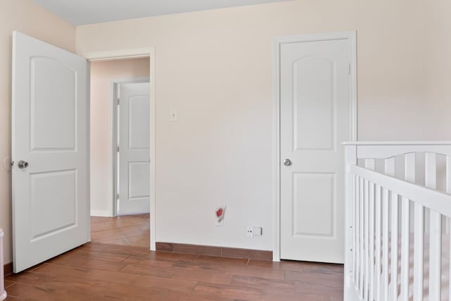 7220 Elderberry Ln, Dallas, TX 75249 - unfurnished bedroom with wood finished floors and baseboards
