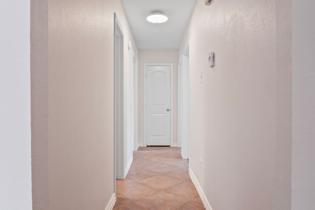 7220 Elderberry Ln, Dallas, TX 75249 - hallway with baseboards and light tile patterned floors