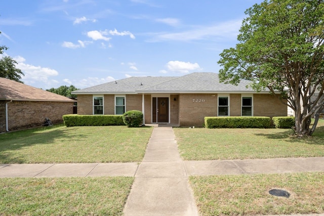 7220 Elderberry Ln, Dallas, TX 75249 - ranch-style home with a front lawn, brick siding, and a shingled roof