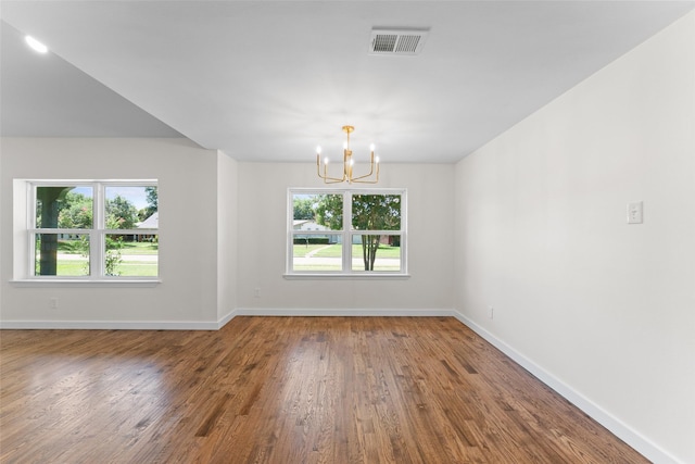 1315 Dunbarton Dr, Richardson, TX 75081 - unfurnished room featuring a chandelier and wood finished floors