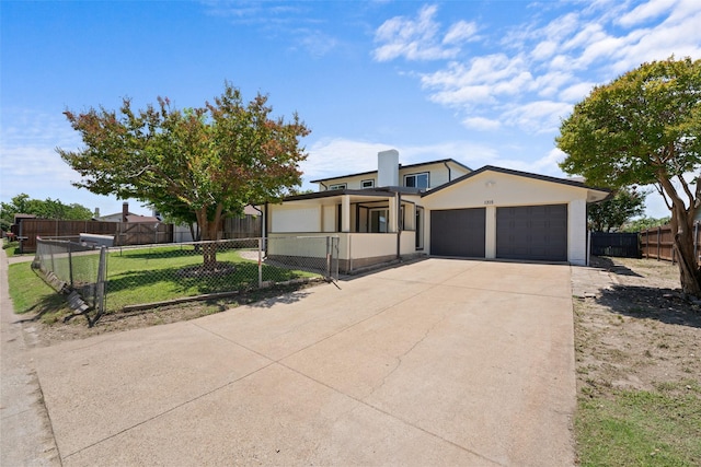1315 Dunbarton Dr, Richardson, TX 75081 - view of front facade with concrete driveway, a garage, a fenced front yard, and stucco siding