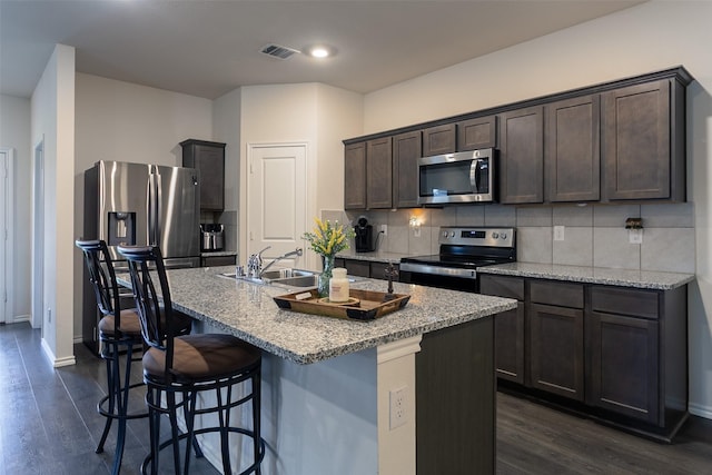 408 Cultivator Ct, Josephine, TX 75189 - kitchen with stainless steel appliances, dark brown cabinetry, dark wood-style flooring, tasteful backsplash, and recessed lighting