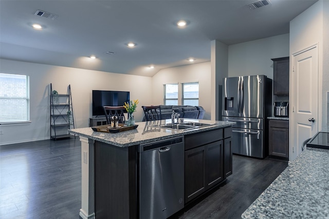 408 Cultivator Ct, Josephine, TX 75189 - kitchen with stainless steel appliances, open floor plan, a kitchen island with sink, dark wood-style floors, and light stone counters