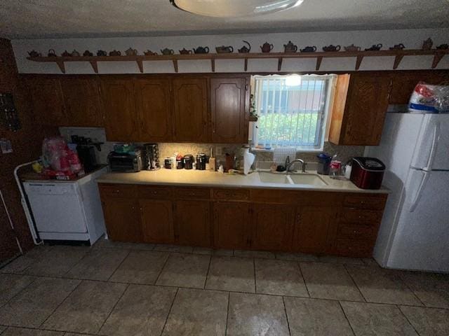 4411 Marigold Trl, Mesquite, TX 75150 - kitchen with freestanding refrigerator, light countertops, washer / clothes dryer, light tile patterned floors, and tasteful backsplash