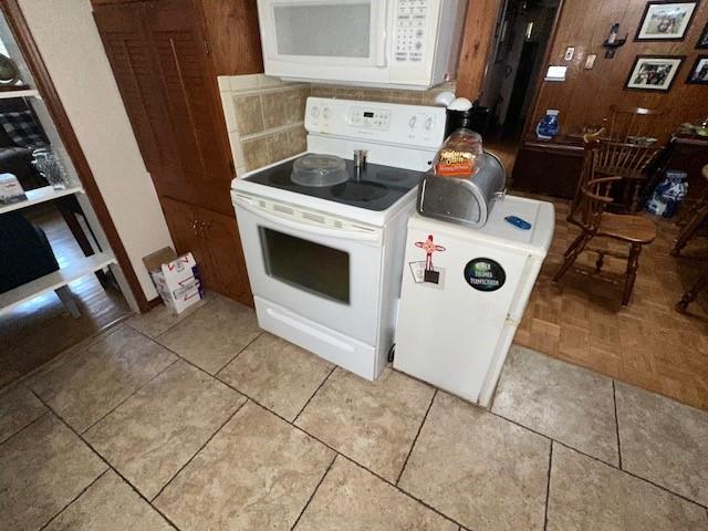 4411 Marigold Trl, Mesquite, TX 75150 - kitchen with white appliances and wooden walls