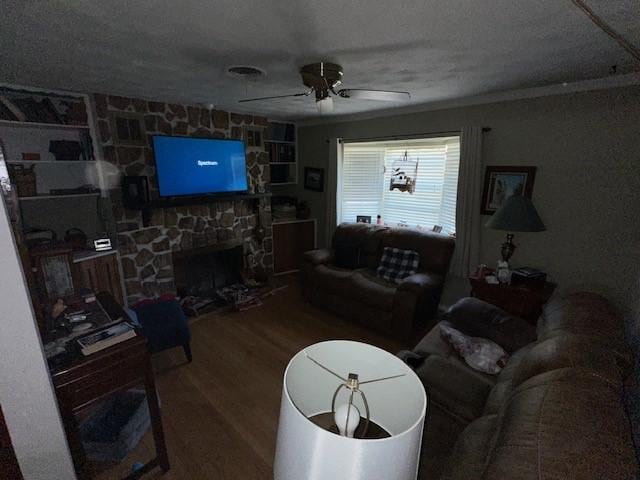 4411 Marigold Trl, Mesquite, TX 75150 - living area featuring wood finished floors, a ceiling fan, and a fireplace