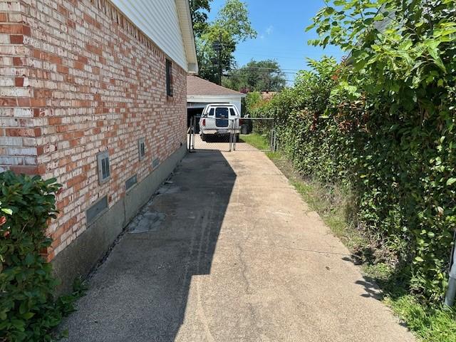 4411 Marigold Trl, Mesquite, TX 75150 - view of home's exterior with crawl space, brick siding, and a gate