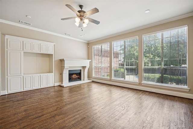 1316 Comal Dr, Allen, TX 75013 - unfurnished living room featuring plenty of natural light, a ceiling fan, a lit fireplace, and ornamental molding