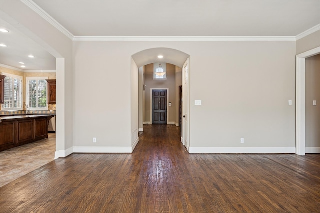 1316 Comal Dr, Allen, TX 75013 - empty room featuring ornamental molding, arched walkways, and dark wood-type flooring