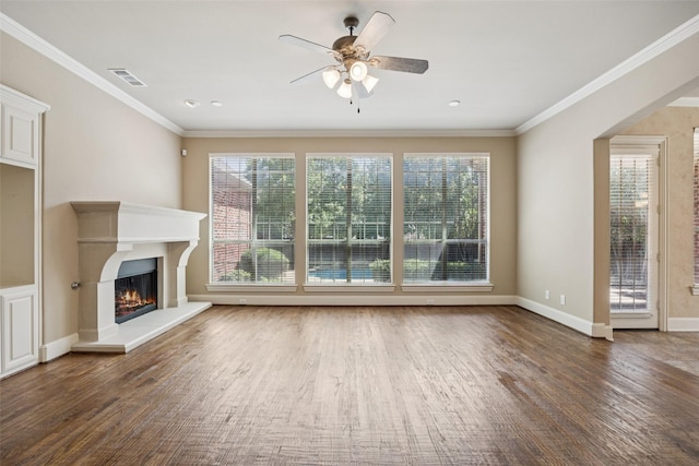1316 Comal Dr, Allen, TX 75013 - unfurnished living room with ceiling fan, wood finished floors, healthy amount of natural light, crown molding, and a warm lit fireplace