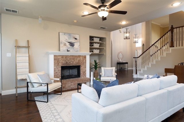 9705 Southern Hills Dr, Plano, TX 75025 - living room featuring built in shelves, a ceiling fan, a fireplace, wood finished floors, and recessed lighting