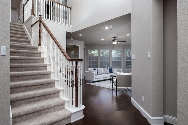9705 Southern Hills Dr, Plano, TX 75025 - stairway featuring ceiling fan, wood finished floors, a textured wall, and recessed lighting