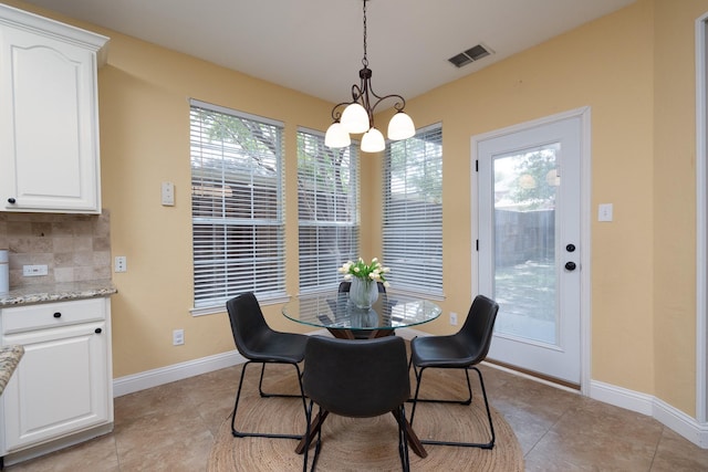 9705 Southern Hills Dr, Plano, TX 75025 - dining area featuring a chandelier, light tile patterned floors, and plenty of natural light