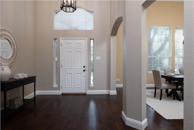 9705 Southern Hills Dr, Plano, TX 75025 - entryway featuring arched walkways, dark wood-style flooring, and a chandelier