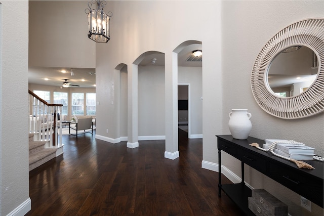 9705 Southern Hills Dr, Plano, TX 75025 - entrance foyer featuring wood finished floors, stairway, ceiling fan, and arched walkways