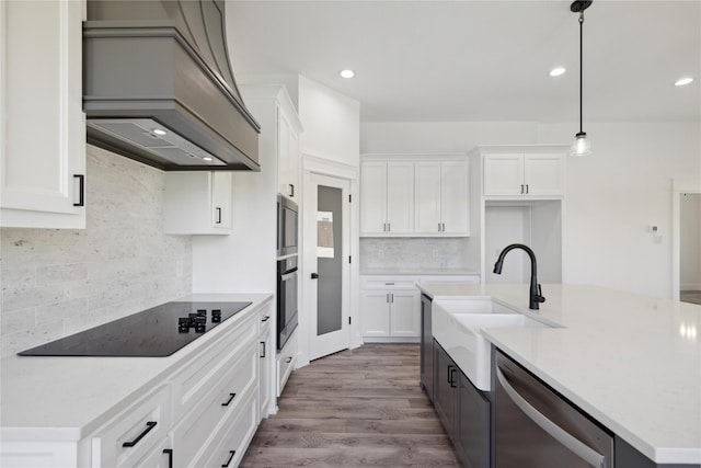 2700 NW 22nd St, Fort Worth, TX 76106 - kitchen featuring appliances with stainless steel finishes, custom exhaust hood, tasteful backsplash, white cabinetry, and recessed lighting
