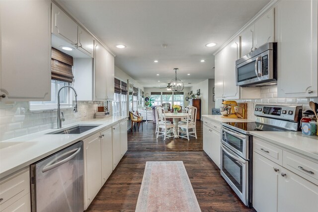 4321 El Campo Ave, Fort Worth, TX 76107 - kitchen featuring appliances with stainless steel finishes, recessed lighting, white cabinets, dark wood finished floors, and decorative backsplash