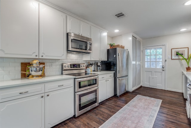 4321 El Campo Ave, Fort Worth, TX 76107 - kitchen featuring stainless steel appliances, dark wood-type flooring, white cabinetry, backsplash, and recessed lighting