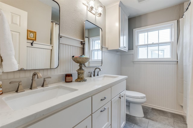 4321 El Campo Ave, Fort Worth, TX 76107 - bathroom featuring double vanity, wainscoting, tile patterned floors, and a shower with curtain