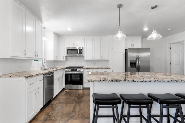 3501 Alta Vista Dr, Waco, TX 76706 - kitchen with appliances with stainless steel finishes, a kitchen breakfast bar, decorative backsplash, and white cabinetry