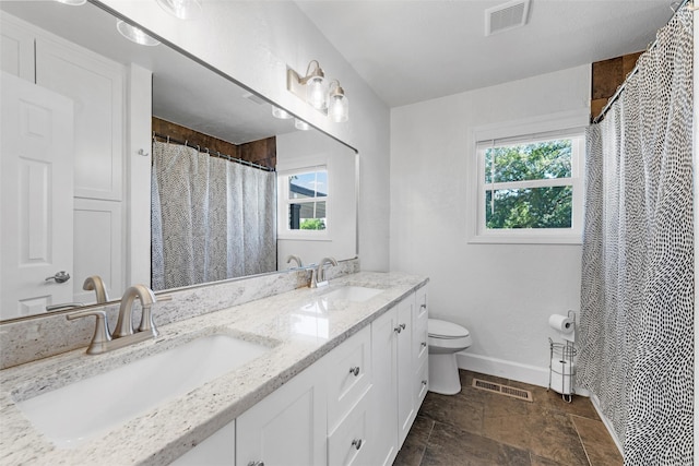 3501 Alta Vista Dr, Waco, TX 76706 - bathroom featuring double vanity, stone finish floors, and curtained shower