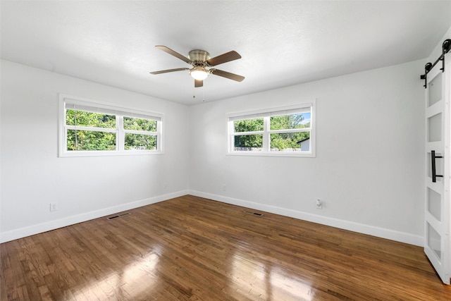 3501 Alta Vista Dr, Waco, TX 76706 - empty room with a barn door, a ceiling fan, and wood finished floors