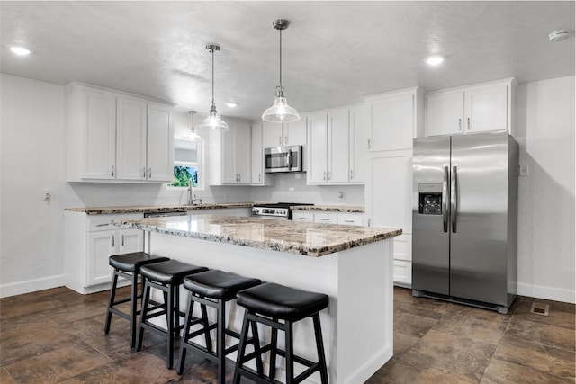 3501 Alta Vista Dr, Waco, TX 76706 - kitchen with stainless steel appliances, white cabinets, a kitchen island, and recessed lighting