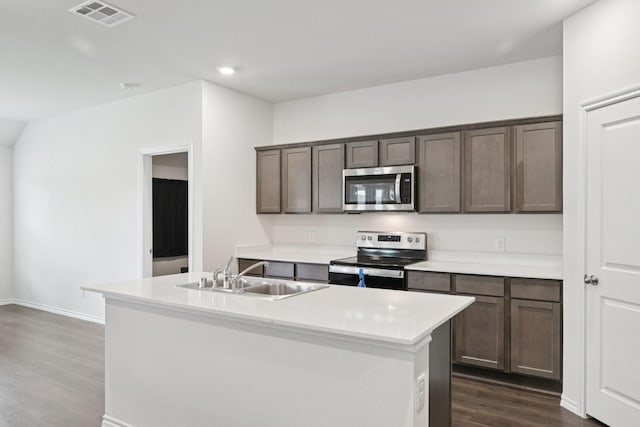 288 Thoroughbred St, Waxahachie, TX 75165 - kitchen featuring stainless steel appliances, dark wood finished floors, light countertops, dark brown cabinetry, and recessed lighting