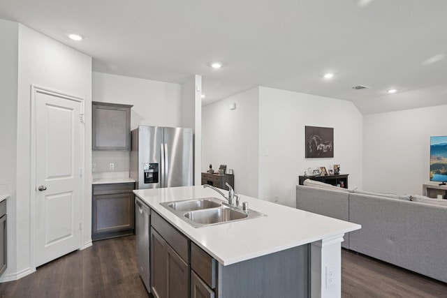 288 Thoroughbred St, Waxahachie, TX 75165 - kitchen featuring appliances with stainless steel finishes, open floor plan, dark wood finished floors, recessed lighting, and light countertops