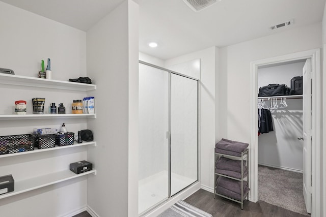 288 Thoroughbred St, Waxahachie, TX 75165 - full bathroom with wood finished floors, a shower stall, a walk in closet, and recessed lighting