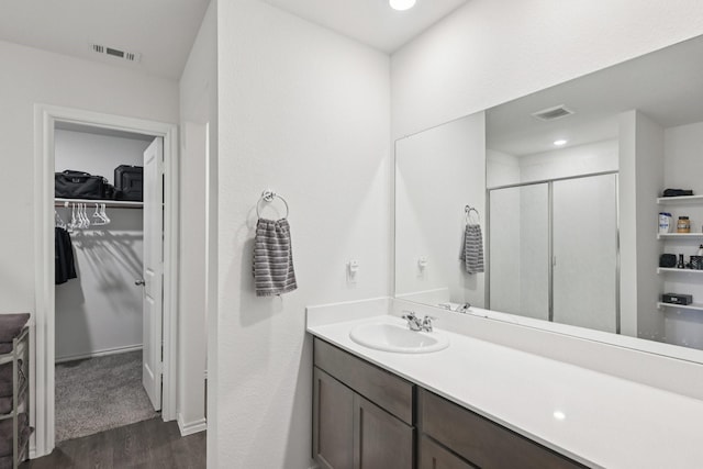 288 Thoroughbred St, Waxahachie, TX 75165 - full bathroom featuring wood finished floors, a stall shower, a walk in closet, and vanity