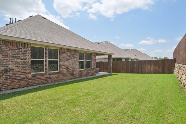 288 Thoroughbred St, Waxahachie, TX 75165 - rear view of property with a fenced backyard, brick siding, and a shingled roof