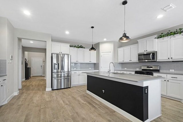 1160 Kirkham Way, Fort Worth, TX 76247 - kitchen featuring appliances with stainless steel finishes, tasteful backsplash, light wood finished floors, light countertops, and white cabinets