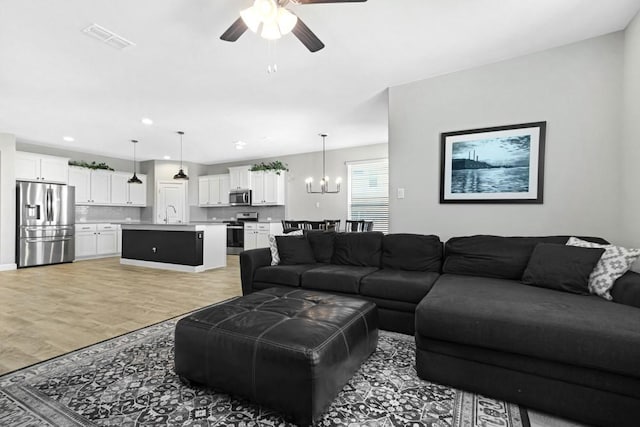 1160 Kirkham Way, Fort Worth, TX 76247 - living room with ceiling fan, a chandelier, light wood finished floors, and recessed lighting