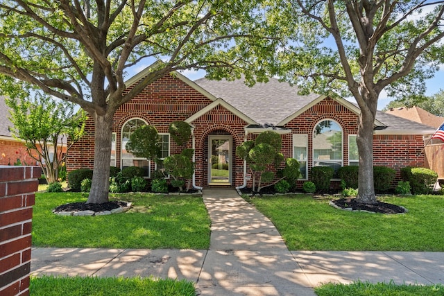 416 Springhill Dr, Hurst, TX 76054 - view of front of property featuring brick siding, a shingled roof, and a front lawn